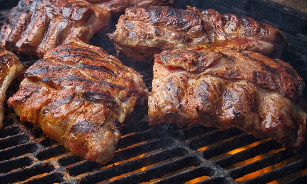 San Antonio BBQ ribs being cooked on an American Outdoor Grill.