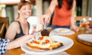 A man putting a pizza into an Alfa Pizza Oven.